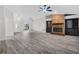 Open-concept living room with brick fireplace and built-in shelving, bright and spacious at 157 Ambergate Ct, Debary, FL 32713