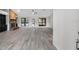 Open living room featuring hardwood floors, a brick fireplace, and abundant natural light from large windows at 157 Ambergate Ct, Debary, FL 32713