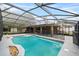 Inviting in-ground pool enclosed in a screened patio, offering a private and enjoyable outdoor oasis at 157 Ambergate Ct, Debary, FL 32713