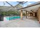 Outdoor pool with screened enclosure and covered patio, ideal for entertaining and enjoying the outdoors at 157 Ambergate Ct, Debary, FL 32713