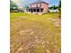 Large backyard featuring a well-maintained lawn and the exterior screened-in living space at 16041 Lagoon Dr, Clermont, FL 34711