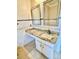 A nice bathroom features a vanity with a sink, cabinets, and a mirror at 16041 Lagoon Dr, Clermont, FL 34711