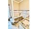 Elegant bathroom featuring a soaking tub with tiled surround, and a stylish vanity with granite countertops at 16041 Lagoon Dr, Clermont, FL 34711