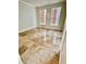 Bright bedroom featuring tan tile flooring, neutral walls, and two large windows for ample natural light at 16041 Lagoon Dr, Clermont, FL 34711