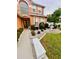 Charming two-story home exterior with a water fountain and lush landscaping at 16041 Lagoon Dr, Clermont, FL 34711