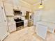 Bright kitchen featuring stainless steel appliances, granite countertops, and ample cabinet space at 16041 Lagoon Dr, Clermont, FL 34711
