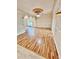 Spacious living room with hardwood floors, decorative columns, and tray ceiling at 16041 Lagoon Dr, Clermont, FL 34711