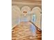 Spacious living room featuring elegant arches and beautiful hardwood floors, offering a bright and airy atmosphere at 16041 Lagoon Dr, Clermont, FL 34711