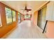 Spacious covered patio with ceiling fans and multiple windows, offering a bright and airy space at 16041 Lagoon Dr, Clermont, FL 34711
