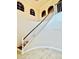Grand staircase with white railings and dark wood accents, creating an impressive focal point in the home's entrance at 16041 Lagoon Dr, Clermont, FL 34711