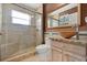 Bathroom with large shower, granite countertop sink, and warm lighting at 219 Old Mill Cir, Kissimmee, FL 34746