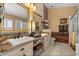 Bathroom with double sinks, granite countertop, framed mirrors, and walk-in glass door shower at 219 Old Mill Cir, Kissimmee, FL 34746