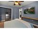 Bedroom featuring blue walls, ceiling fan, TV, and a closet with stainless steel mini fridge at 219 Old Mill Cir, Kissimmee, FL 34746