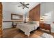 Cozy bedroom features hardwood floors, rustic wood accent wall, and stylish furnishings at 219 Old Mill Cir, Kissimmee, FL 34746