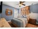 Bedroom with wooden headboard, matching side tables, shutters, and wood flooring at 219 Old Mill Cir, Kissimmee, FL 34746