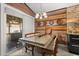 A delightful dining area with wood paneling, stylish lighting, and sliding glass door to the outside patio at 219 Old Mill Cir, Kissimmee, FL 34746