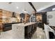 Elegant kitchen with a large granite island, seating for four, and modern stainless steel appliances at 219 Old Mill Cir, Kissimmee, FL 34746