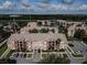 Aerial view of colorful apartment complex and beautiful landscape with pond in the background at 2208 Antigua Pl # 932, Kissimmee, FL 34741