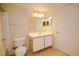 Standard bathroom with a single sink vanity, toilet, and large mirror at 2208 Antigua Pl # 932, Kissimmee, FL 34741