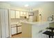 Kitchen featuring bar seating, tile floor, and white cabinets at 2208 Antigua Pl # 932, Kissimmee, FL 34741