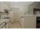 Efficient kitchen featuring white appliances, tile flooring, and ample cabinet space at 2208 Antigua Pl # 932, Kissimmee, FL 34741