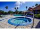 Attractive community pool and spa area, surrounded by lounge chairs and lush landscaping at 2208 Antigua Pl # 932, Kissimmee, FL 34741