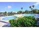 Community pool area with a hot tub, lounge chairs, and palm trees in a landscaped setting at 2208 Antigua Pl # 932, Kissimmee, FL 34741
