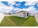 Exterior view of the backyard with privacy fence, lawn, and covered patio at 2226 Majestic Span Ave, Eagle Lake, FL 33839