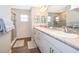 Bright bathroom featuring double sinks with granite counters and a glass-enclosed shower at 2226 Majestic Span Ave, Eagle Lake, FL 33839