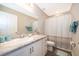 Bright bathroom featuring a granite vanity countertop, ample lighting, and a shower-tub combo with stylish curtain at 2226 Majestic Span Ave, Eagle Lake, FL 33839