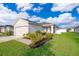 Charming single-story home with a two car garage, lush green lawn, and fresh landscaping under a bright sky at 2226 Majestic Span Ave, Eagle Lake, FL 33839