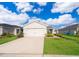 Inviting single-Gathering home boasting a well-manicured lawn, fresh landscaping, and a convenient two-car garage at 2226 Majestic Span Ave, Eagle Lake, FL 33839
