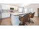 Modern kitchen featuring stainless appliances, white cabinetry, island and breakfast bar at 2226 Majestic Span Ave, Eagle Lake, FL 33839