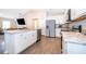 Modern kitchen featuring stainless appliances, white cabinetry and a kitchen island at 2226 Majestic Span Ave, Eagle Lake, FL 33839