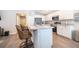 Modern kitchen featuring stainless appliances, white cabinetry and a breakfast bar at 2226 Majestic Span Ave, Eagle Lake, FL 33839