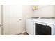 Bright laundry room featuring a new washer and dryer, shelving and storage space at 2226 Majestic Span Ave, Eagle Lake, FL 33839