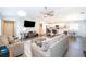 Open-concept living room with a large sectional sofa and a kitchen island at 2226 Majestic Span Ave, Eagle Lake, FL 33839