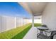 Relaxing covered patio with table and chairs and private fenced in backyard at 2226 Majestic Span Ave, Eagle Lake, FL 33839