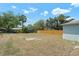 Large backyard surrounded by a new wooden fence, and lush trees at 225 Indiana St, Leesburg, FL 34748