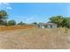 Spacious backyard with healthy grass and a sturdy wooden fence for privacy at 225 Indiana St, Leesburg, FL 34748