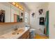 Bathroom with marbled sink, vanity mirror and closet space at 225 Indiana St, Leesburg, FL 34748