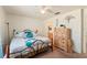 Airy bedroom with a ceiling fan, closet and view into the bathroom at 225 Indiana St, Leesburg, FL 34748