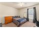Cozy bedroom with dark curtains, comfortable lighting and a modern workspace at 225 Indiana St, Leesburg, FL 34748