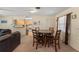 Cozy dining area featuring a wooden table and chairs, near the living room and kitchen at 225 Indiana St, Leesburg, FL 34748