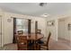 Charming dining area with a wooden table, chairs, and natural light from a nearby window at 225 Indiana St, Leesburg, FL 34748