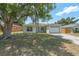 Charming single-story home with an attached garage and a well-maintained front lawn at 225 Indiana St, Leesburg, FL 34748