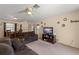 Spacious living room with plush seating, a TV, and an adjacent dining area at 225 Indiana St, Leesburg, FL 34748