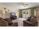 Inviting living room featuring brown couches, and a decorative wall at 225 Indiana St, Leesburg, FL 34748