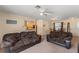 Open concept living space with a living room and dining area and a peek to the kitchen at 225 Indiana St, Leesburg, FL 34748