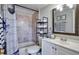 Cozy bathroom with neutral tile, framed mirror and patterned shower curtain at 2714 Hunt Club Ln, Orlando, FL 32826